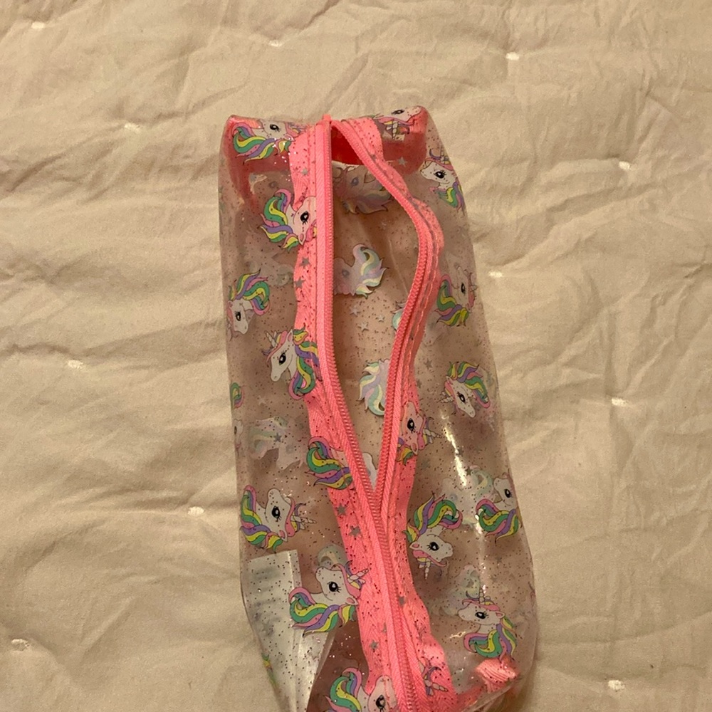 A pink, white, clear unicorn pouch. From: H&M. Name: Unicorn Pouch - Picture 5 of 5